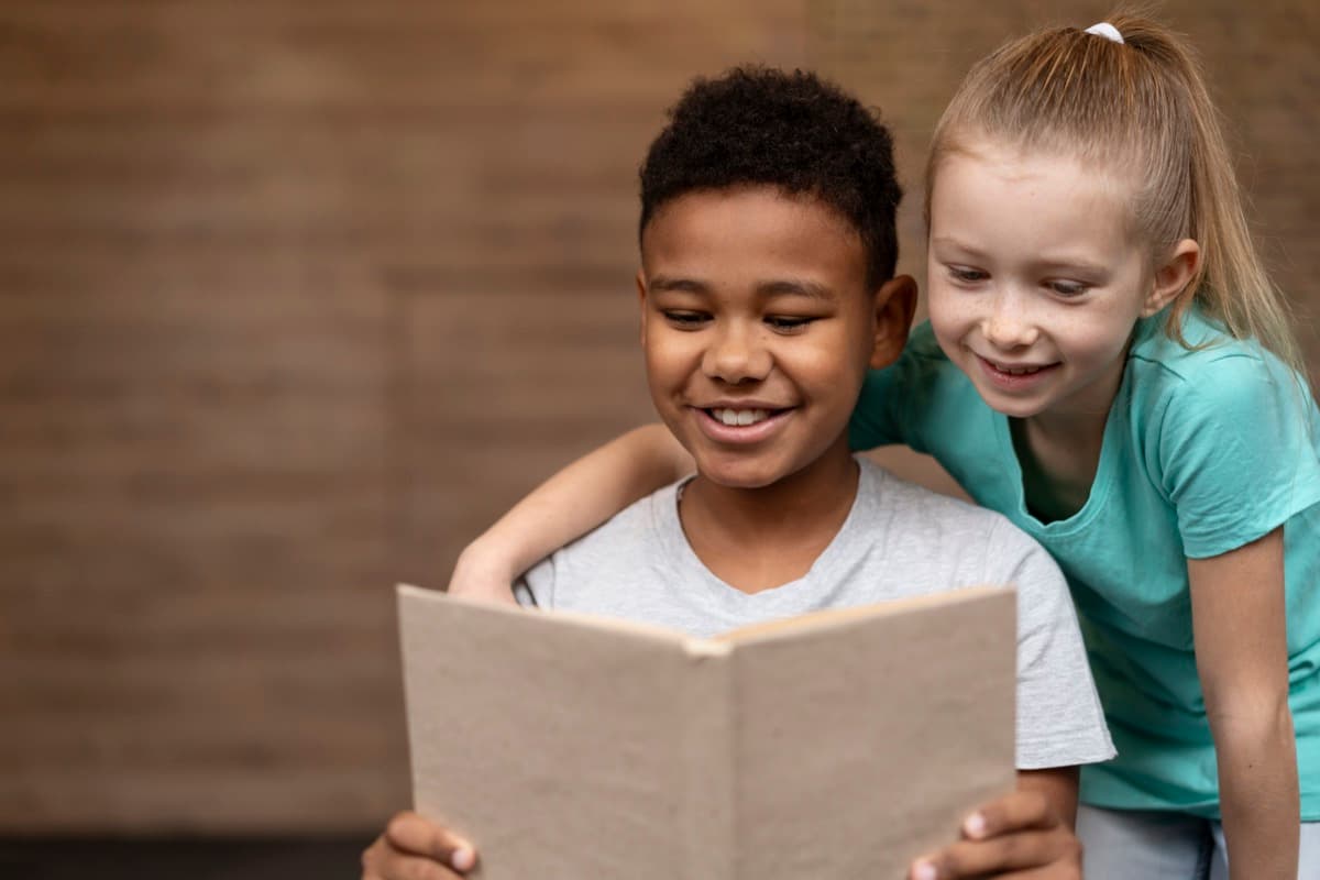 Two children reading a book together