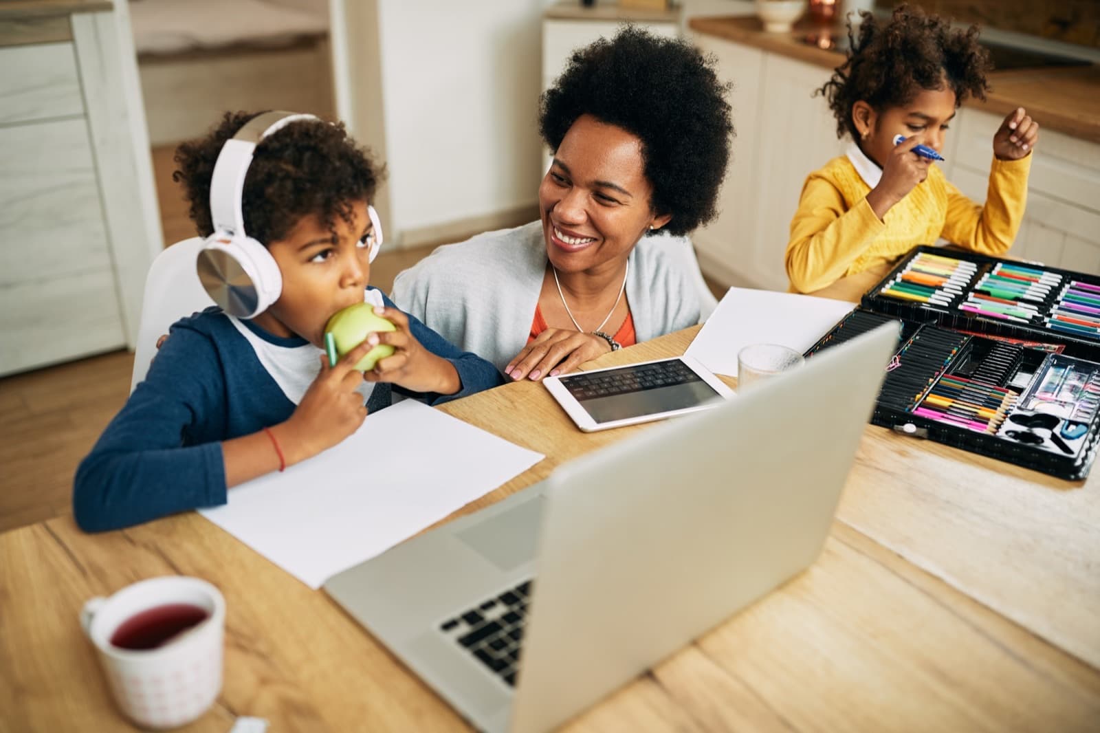 A mother homeschooling her two children at home