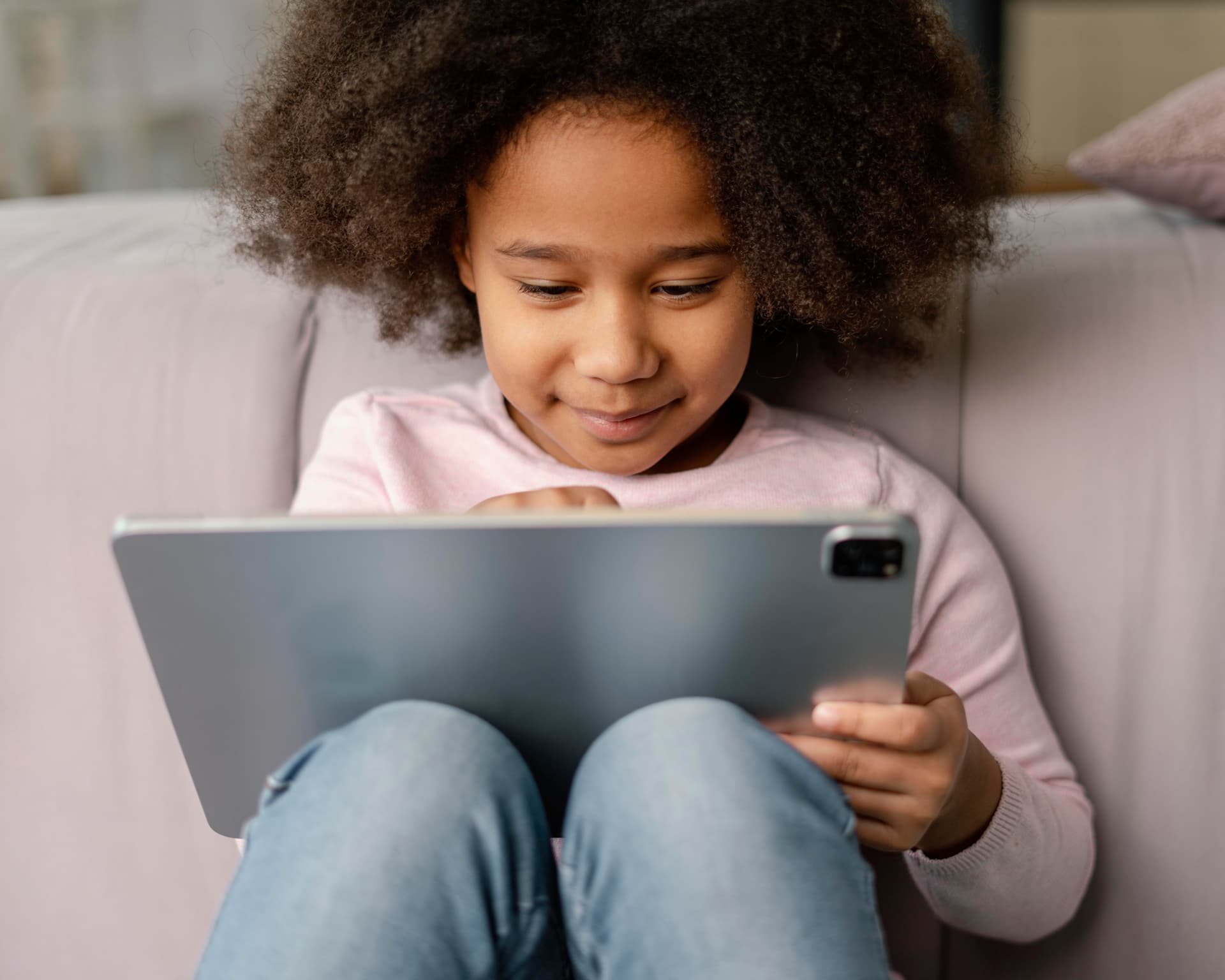 A young learner working on a tablet at home
