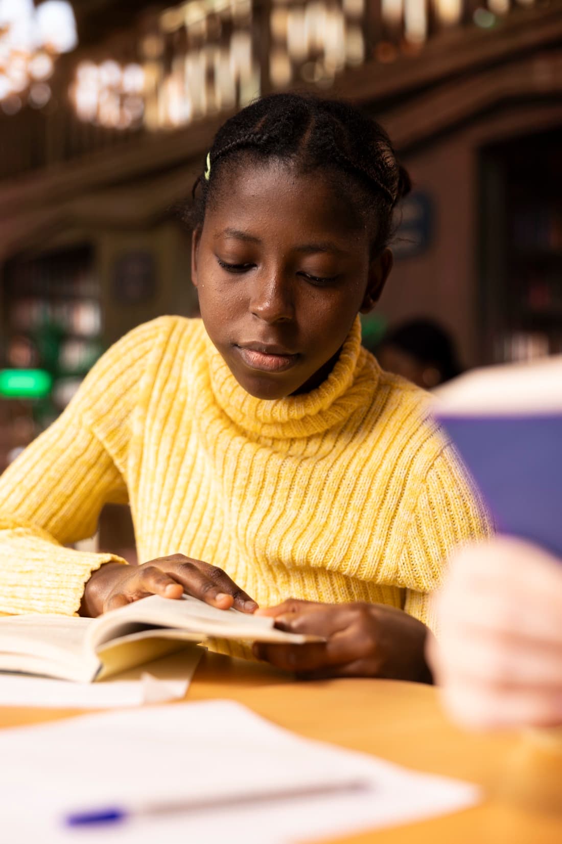 A child focused on reading at home