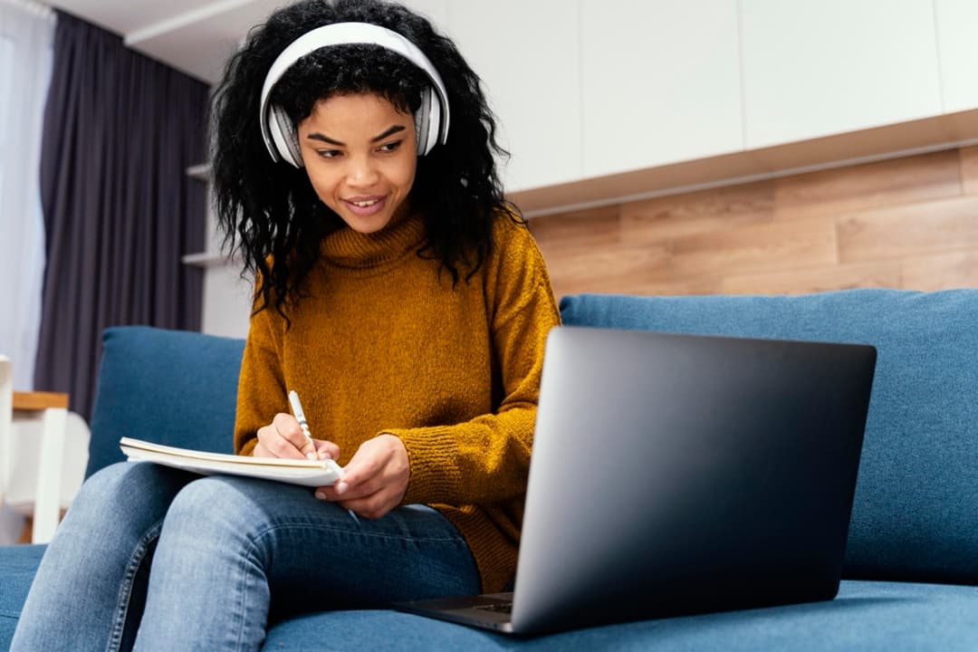 A parent working through fees at a laptop