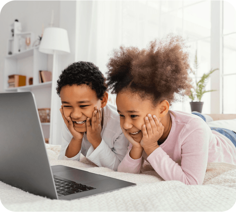 Two children using the interactive Learn to Read programme on a laptop