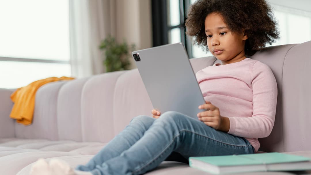 A learner working on a tablet at home