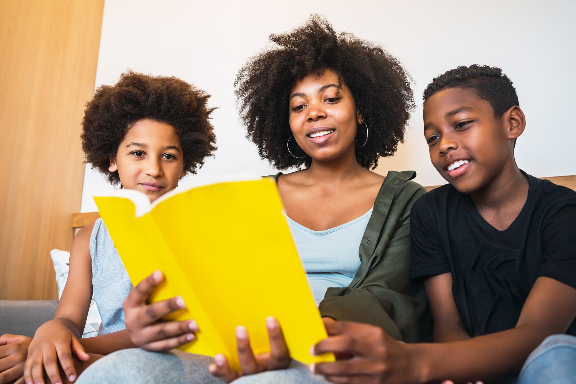 A parent and children learning together at home